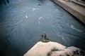 Skopje / North Macedonia, May 12 2019: Bronze statue of Ã¢â¬ÅThe City BeachÃ¢â¬Â or Ã¢â¬ÅThe Female SwimmerÃ¢â¬Â under the Stone Bridge Royalty Free Stock Photo